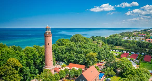 Lighthouse and blue sky by Baltic Sea, aerial view of Poland
