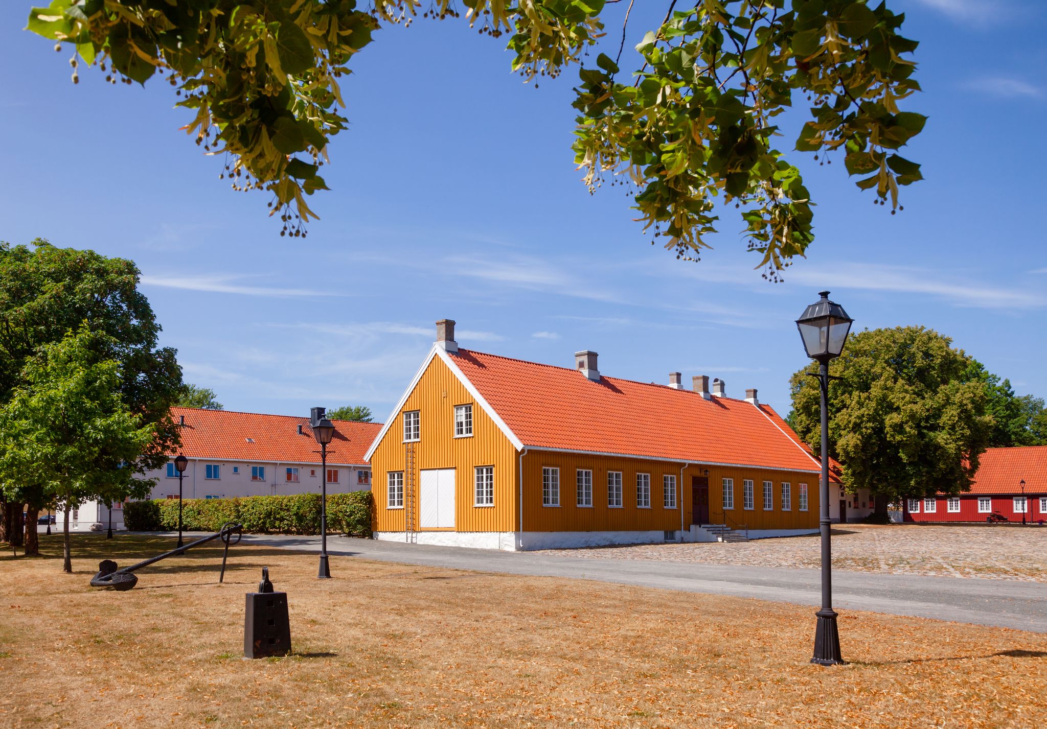 Ochre and red coloured historic buildings at Staverns Fortress (Fredriksvern), Larvik, Vestfold, Norway
