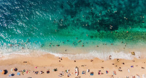 Drone footage of people sunbathing on Kaputaş beach near Kalkan - Kaş, Antalya, Turkey.