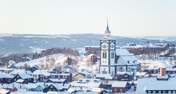 photo of view of A beautiful tower of Roros church in central Norway. World heritage site. Winter town landscape.
