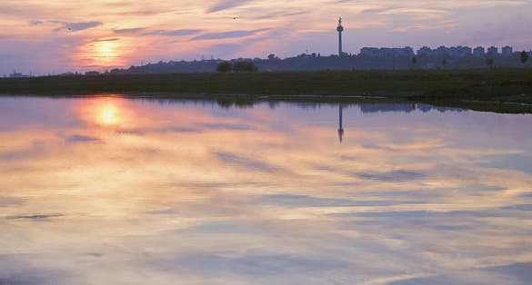 Photo of sunset reflection on Danube river in Galati, Romania.
