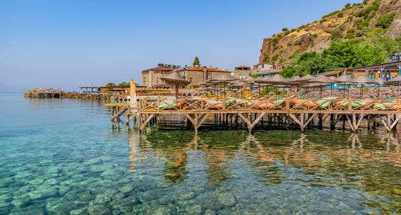 Beach at historical Assos town coast of Canakkale, Turkey. Preparation for the sea season. Ready-made writing area in holiday themed graphic work.