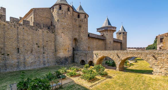 Photo of scenic view of Carcassone medieval city in France against summer sky.