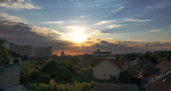 photo of view of  Sunset in a small city with houses, aerial view of sunset in Satu Mare Romania.