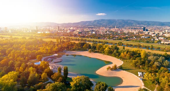 Photo of Bundek lake and city of Zagreb aerial autumn sun haze view.
