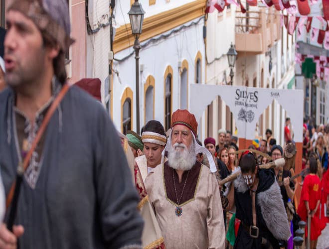 Costumed performers marching through Silves during the Medieval Fair, a festive event in Portugal in August..jpg