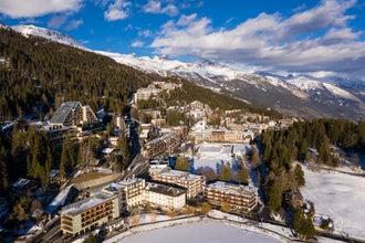 Photo of aerial view of the famous Crans Montana village in the Swiss alps in Canton Valais in Switzerland. The village is a famous tourism and ski resort destination.