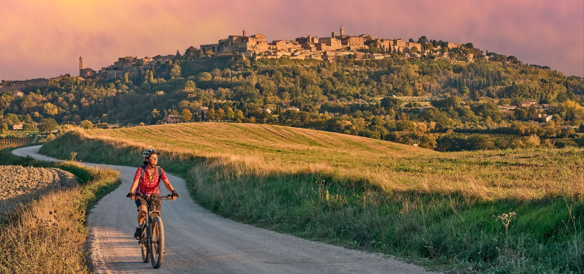 Cycling through the Tuscan countryside on a warm late afternoon in Italy..jpg