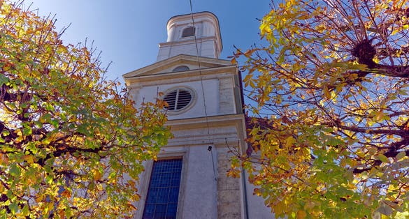 Photo of white catholic church at the old town of Olten, Canton Solothurn, in bright sunlight on a sunny autumn day ,Switzerland.