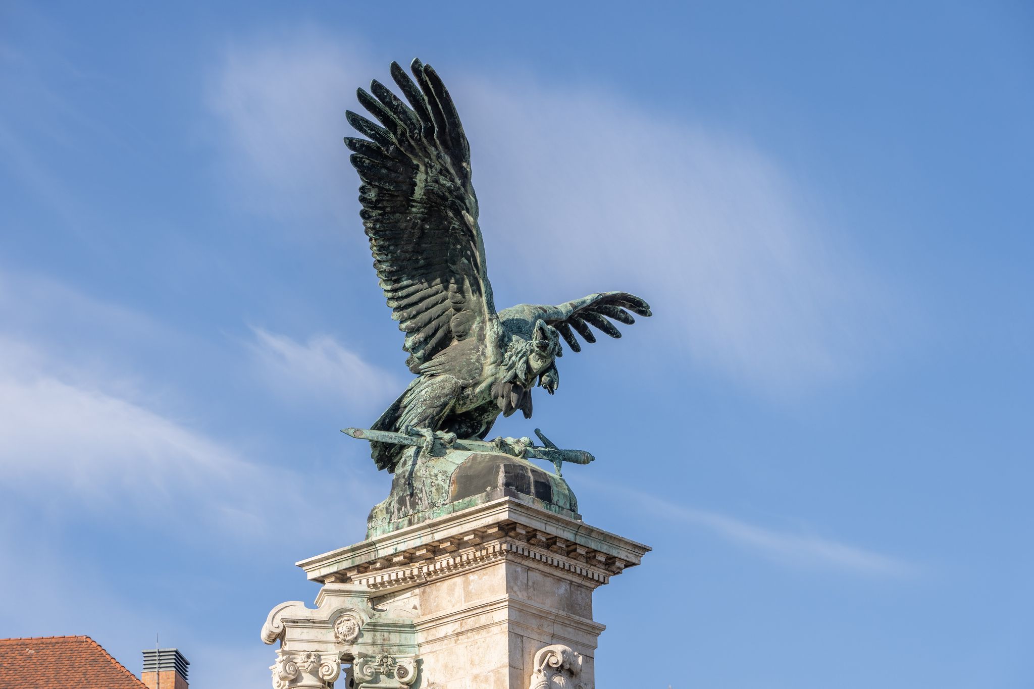 photo of view of Bronze turul Bird statue on top of column at Sandor Palace on Buda Hill in Budapest winter morning, Tatabánya, Hungary.