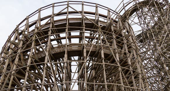 photo of Balder roller coaster structure with wooden beams rising high into the sky on Liseberg amusement park in Gothenburg, Sweden.