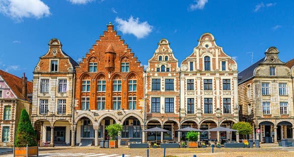 Flemish-Baroque-style townhouses buildings on La Grand Place square in Arras historical city center, blue sky in summer day, Artois, Pas-de-Calais department, Hauts-de-France Region, Northern France