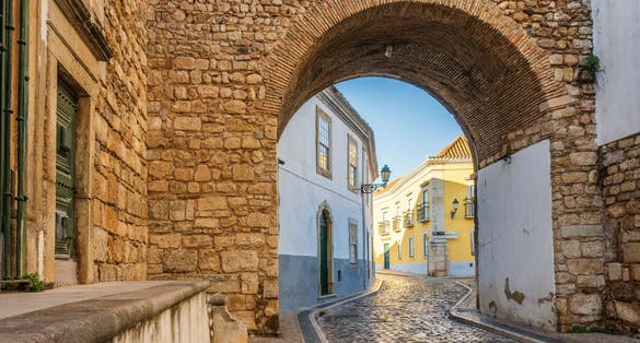 Photo of resting Arch in medieval walls is one of 4 entrances to the old town in Faro, Algarve, Portugal.