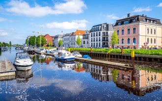 Photo of aerial view of the city of Bremerhaven with the harbor and traditional sailing-ships, Germany.