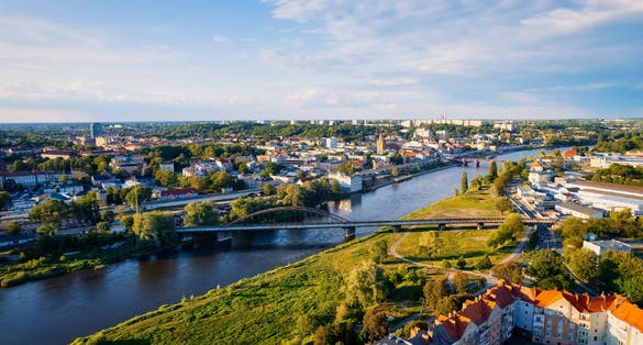 In Gorzów Wielkopolski, a drone photo was taken on a sunny day featuring the River Warta, the Cathedral, and the city center