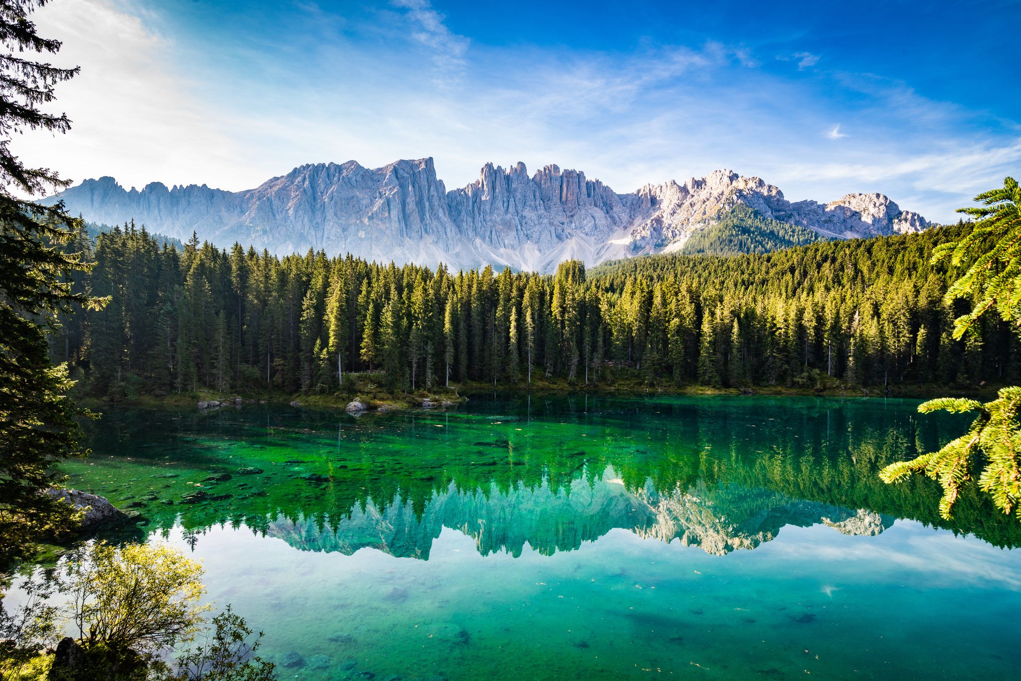 Sunny morning in Lake Carezza / Lago di Carezza / Karersee in Dolomites (Dolomiti), South Tyrol, Italy.