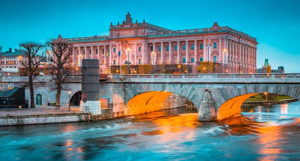photo of beautiful view of famous Museum of Medieval Stockholm with Norrbro bridge at twilight in winter, central Stockholm, Sweden.