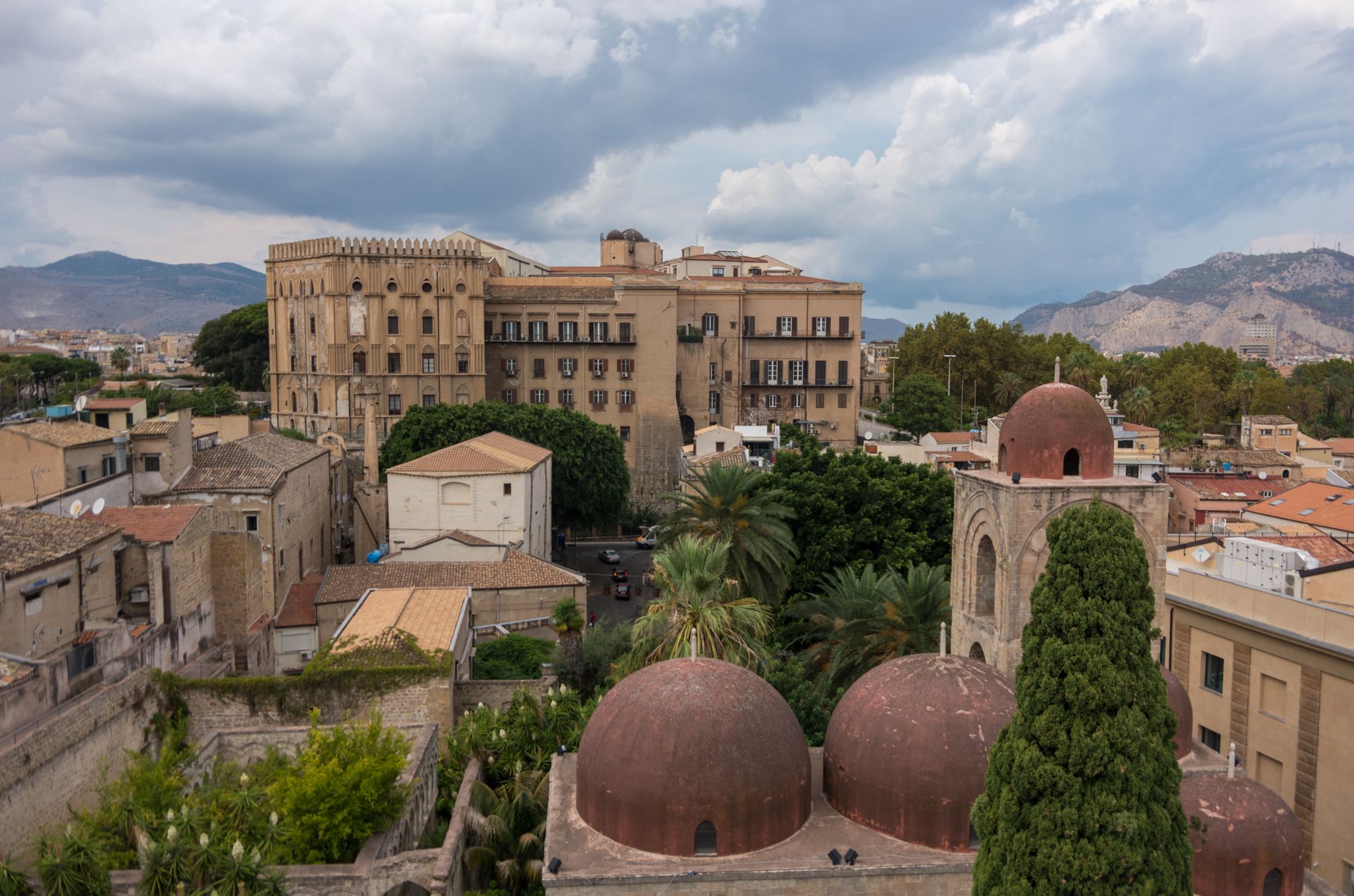 photo of view the famous red domes of the Church of St. John of the Hermits (San Giovanni degli Eremiti) and the Norman Palace (Palazzo dei Normanni) - Palermo, Italy