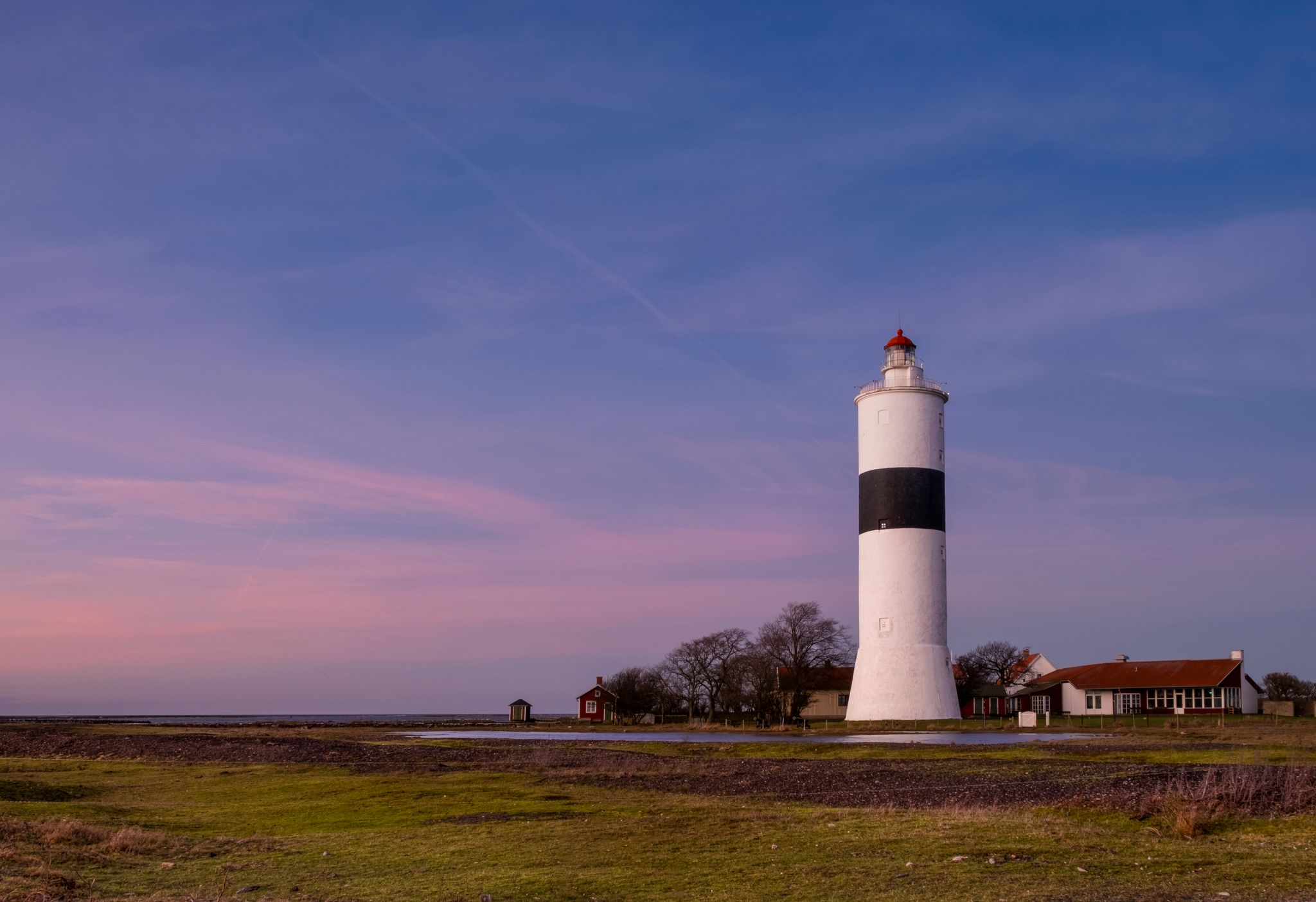photo of Lange Jan lighthouse at evening with beautiful sky. Oland, Sweden.