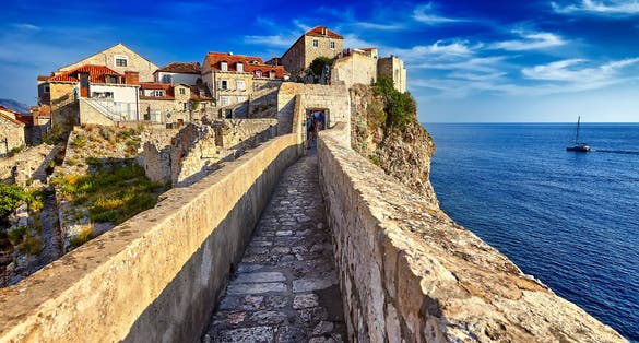 Photo of the Panorama Dubrovnik Old Town roofs at sunset.