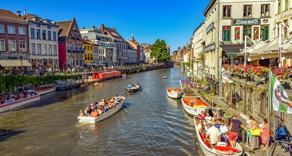 Photo of Row of historic buildings along the tourist boats floating on the river, Ghent, Belgium