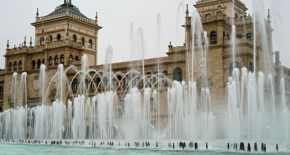 Photo of Zorrilla square fountain in Valladolid Spain with the Town Hall in the background historic buildings of Valladolid tourism of Valladolid Spain .