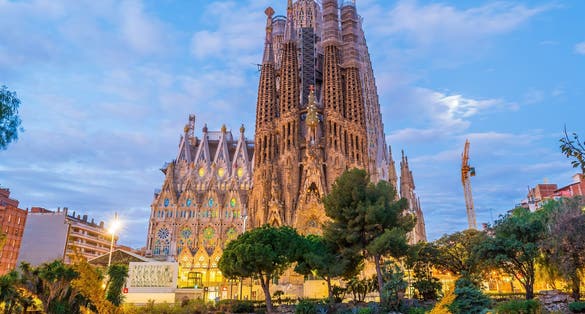Photo of Sagrada Familia by Antonio Gaudi in downtown Barcelona Spain at the evening.