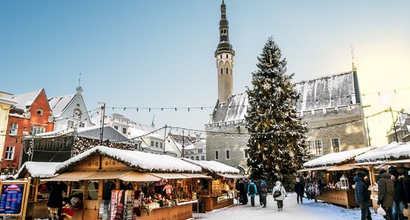 Photo of the Christmas market on town hall square in Tallinn in winter, Estonia.
