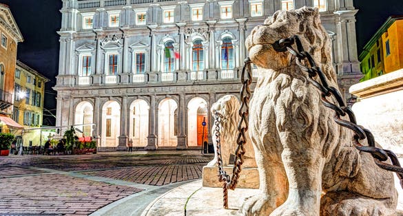 Piazza Vecchia, Citta Alta, Bergamo, Italy. Night view on the square with the beautiful fountain in the center of the square illuminated by night lights.