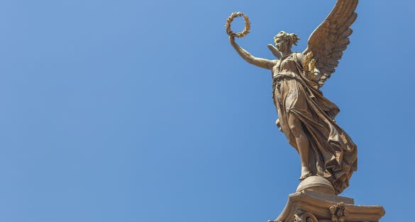 Photo of Statue of an angel in front of the Rudolfinum in Prague, Czech Republic.