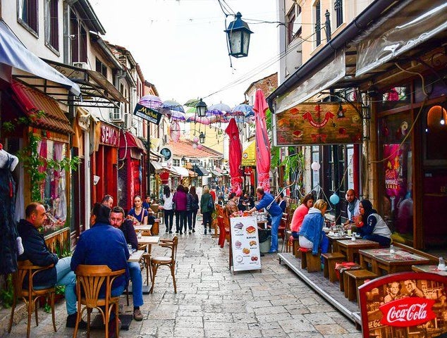 A lively street in the Old Bazaar of Skopje, North Macedonia, with people dining at cafes and walking around..jpg