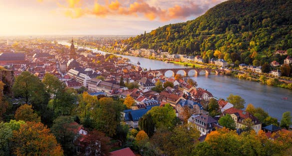 photo of view of Landmark and beautiful Heidelberg town with Neckar river, Germany. Heidelberg town with the famous Karl Theodor old bridge and Heidelberg castle, Heidelberg, Germany.