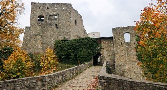 Photo of beautiful autumn view of the main gate of medieval castle Hukvaldy, Czech republic.