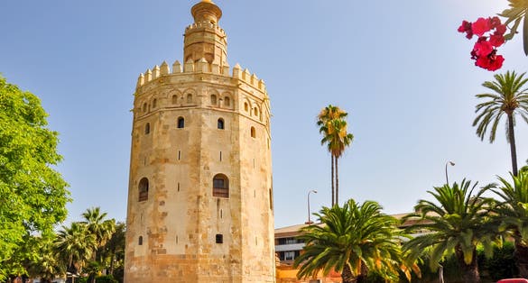 Photo of Tower of Gold (Torre del Oro) on Guadalquivir river embankment, Spain .