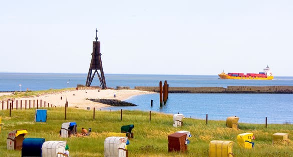 photo of the beach with beach chairs and the Kugelbake in Cuxhaven, Germany.
