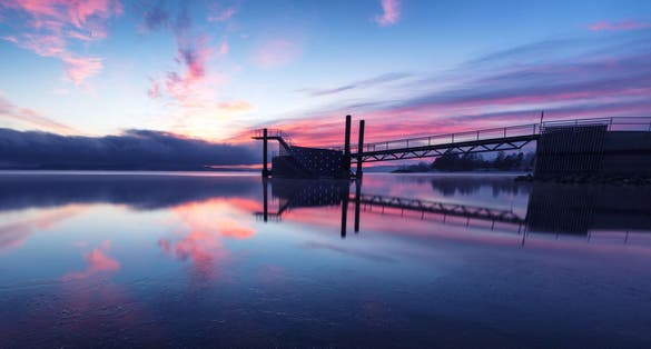 photo of view of Pier with diving tower during sunset located in Hamar, Norway.