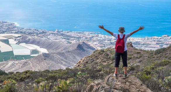Hiker in the mountains of Arona and view of the coast, Tenerife, Canary Islands