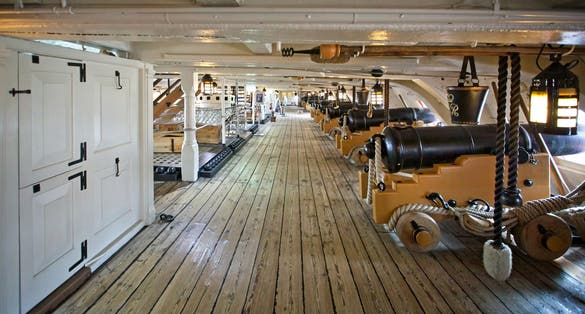 Rows of cannons in the gun deck on board HMS Victory, in Portsmouth Dockyard, Hampshire, UK.