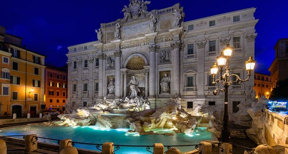 photo of Night view of Rome Trevi Fountain (Fontana di Trevi) in Rome, Italy. Trevi is most famous fountain of Rome. Architecture and landmark of Rome, Rome postcard .
