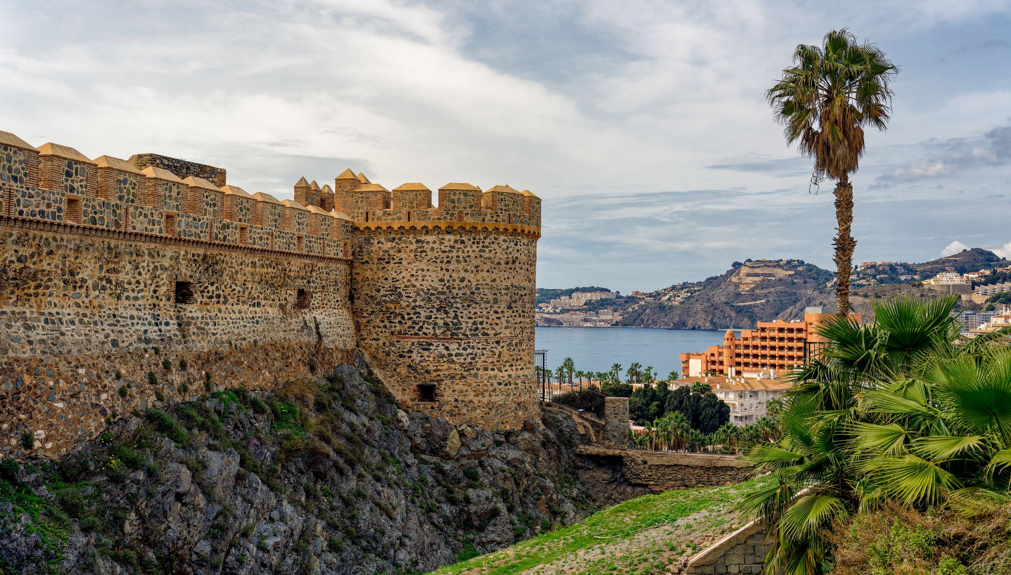 photo of Almuñécar, Spain - A scenic view of a coastal city with white buildings and a blue ocean in the background.