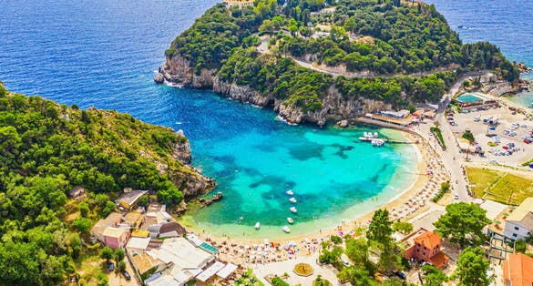 Photo of aerial drone view of famous Paleokastritsa beach resort on Corfu island, Greece.
