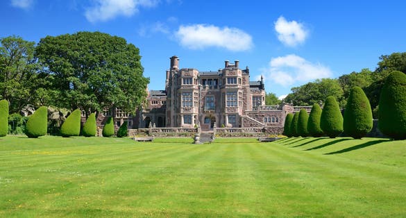 photo of beautiful sunny view at Tjoloholm's castle in panorama landscape in Kungsbacka, Sweden.