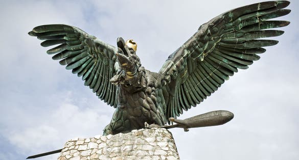 photo of view of Bronze turul Bird statue on top of column at Sandor Palace on Buda Hill in Budapest winter morning, Tatabánya, Hungary.