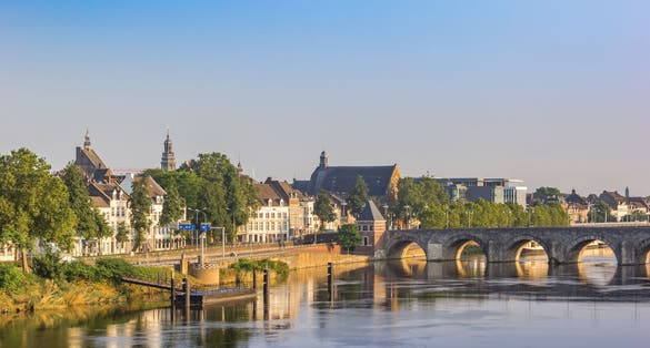 Historic Servaas bridge over river Maas at dawn in Maastricht, Netherlands