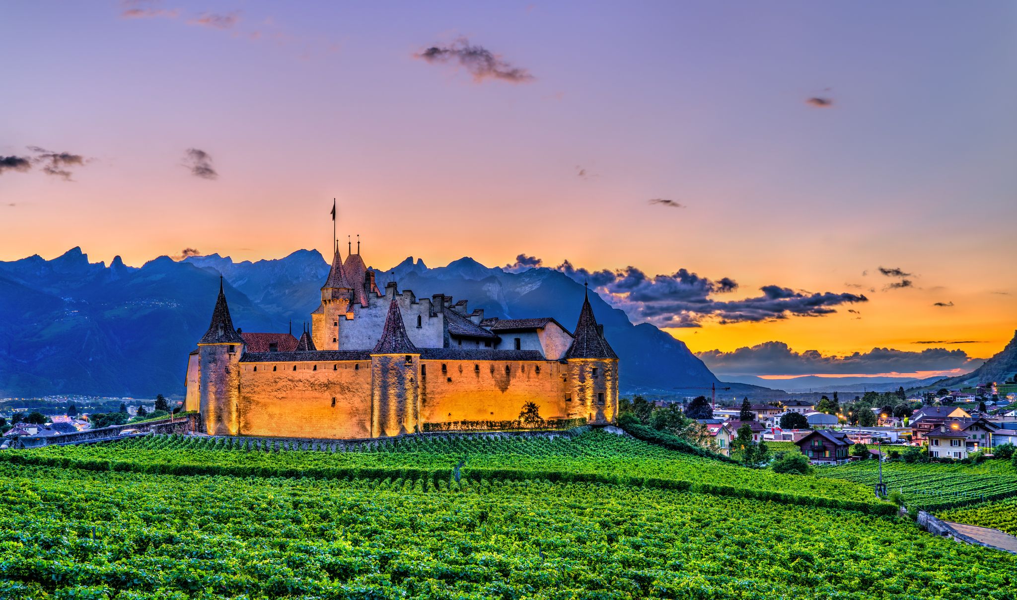 photo of Aigle Castle with vineyards in Aigle in the Canton of Vaud at sunset in Switzerland.