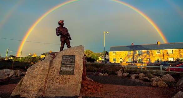 Photo of Tin miner statue at Geevor Tin Mine in Cornwall, England.