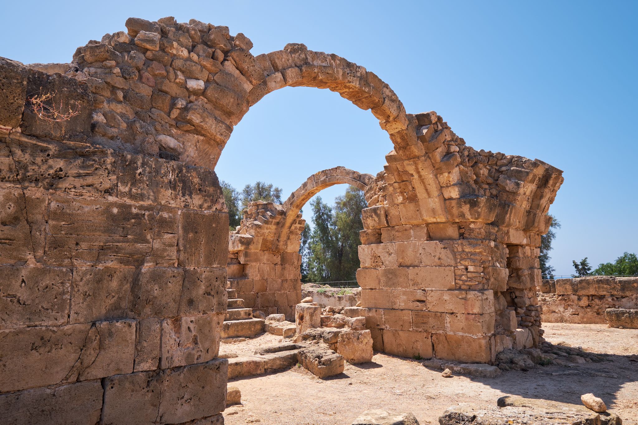 Photo of the arches of Saranta Kolones castle the medieval fortress built on the site of an earlier Byzantine fort. Paphos Archaeological Park, Cyprus.