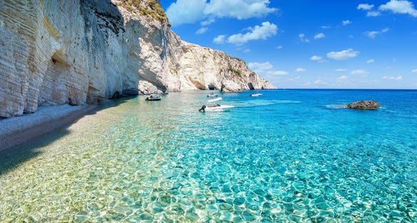 Photo of shining, turquoise sea next to the steep cliffs at the Ionian island of Zakynthos, Greece.