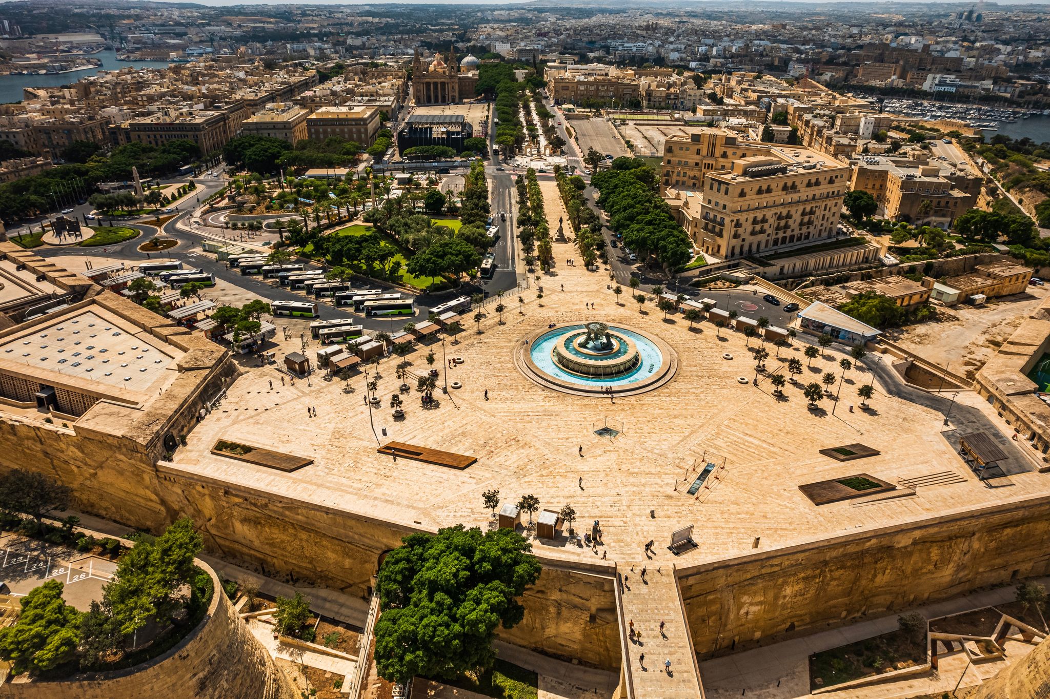 Photo of aerial view of Iconic Triton fountain in front of the Valletta city gate, capital city of Malta.
