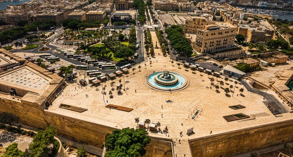 Photo of aerial view of Iconic Triton fountain in front of the Valletta city gate, capital city of Malta.